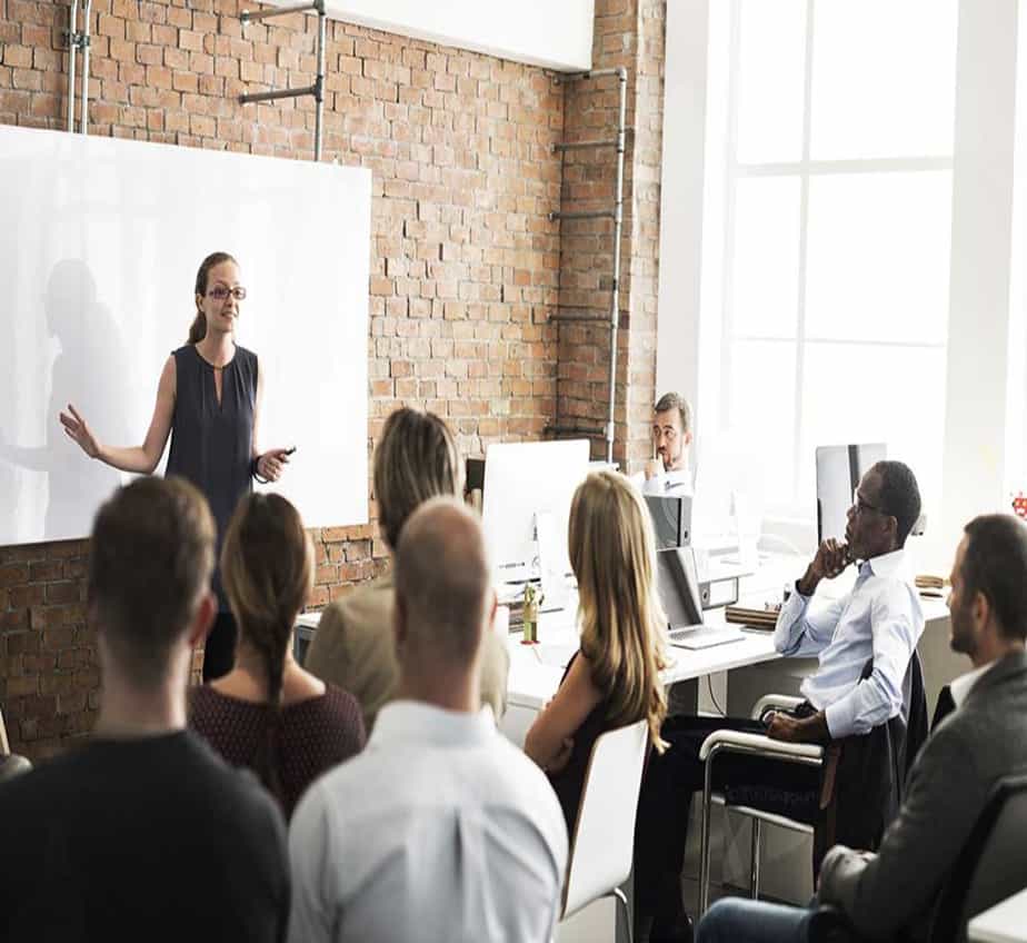 Image of people in a class learning about employee training and development
